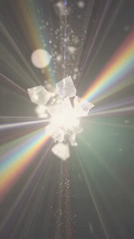 Vertical light burst shattering crystals into rainbow prism beams and ethereal sparkles