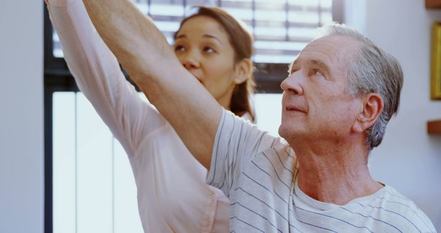 Doctor Assisting Senior Man with Physiotherapy Exercise - Download Free Stock Images Pikwizard.com