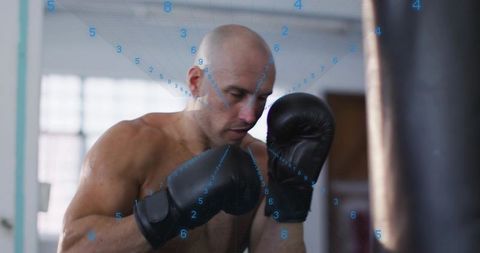 Shirtless boxer training heavy bag with blue digital grid overlay emphasizing focus and technique
