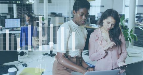 Diverse Businesswomen Collaborating with Digital Charts Overlay