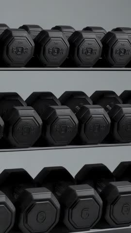 Panning Across Hex Dumbbell Rack Showing Embossed Rubber Weights on Three-Tier Shelving