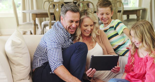 Happy Family Spending Time Together Using Tablet in Living Room - Download Free Stock Images Pikwizard.com