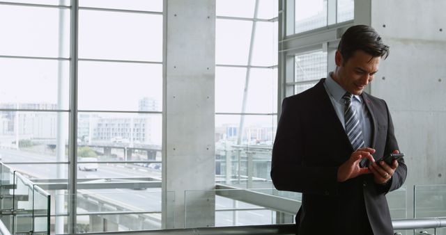 Businessman Typing Message on Smartphone Inside Modern Office Building - Download Free Stock Images Pikwizard.com