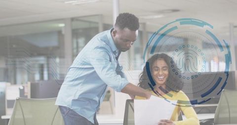 Colleagues collaborating over document with biometric interface overlay in modern office