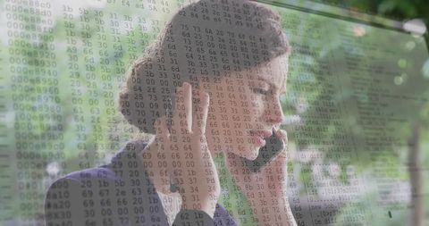 Customer support agent adjusting headset by glass window with cybersecurity code overlay