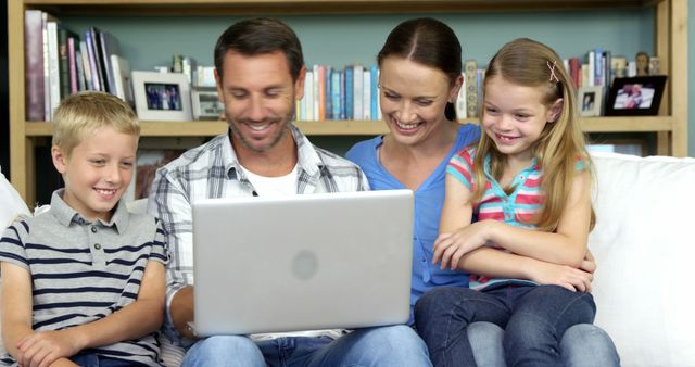 Happy Family Bonding Together Watching Laptop on Living Room Couch - Download Free Stock Images Pikwizard.com