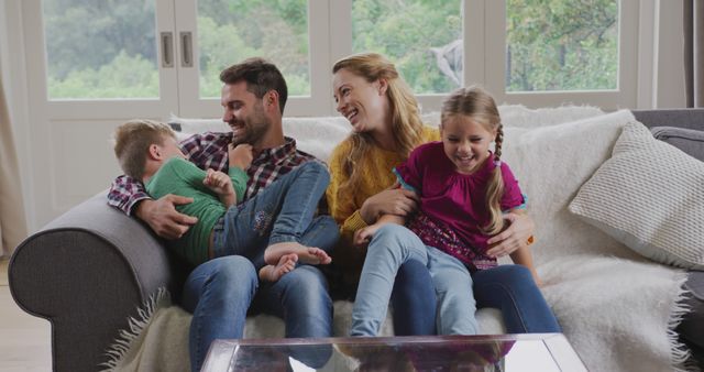 Happy Family Laughing Together on Cozy Sofa at Home - Download Free Stock Images Pikwizard.com