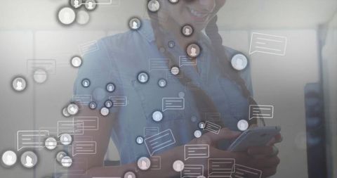 Smiling professional networking on smartphone in modern office