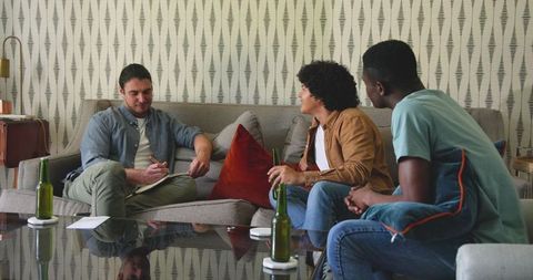 Friends relaxing on sofa in cozy living room