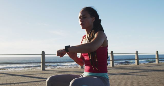 Young Woman Checking Fitness Watch while Exercising Outdoors - Download Free Stock Images Pikwizard.com