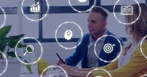 Two colleagues collaborating on laptop with analytics icons for strategy, planning and metrics