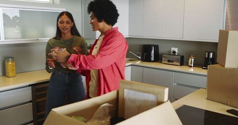 Couple Unpacking in Modern Kitchen During a Home Move