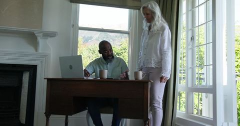 Man Discussing Work with Woman in Bright Home Office