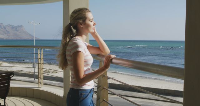 Young Woman Relaxing on Beachfront Balcony - Download Free Stock Images Pikwizard.com