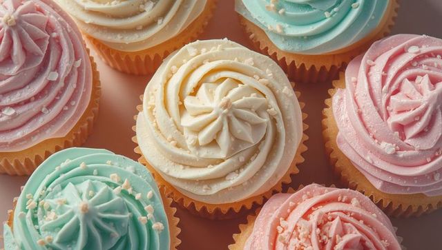 Decorative pastel vanilla cupcakes with sugar sprinkles