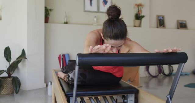 Woman Practicing Pilates on Reformers in Home Workout Space - Download Free Stock Images Pikwizard.com