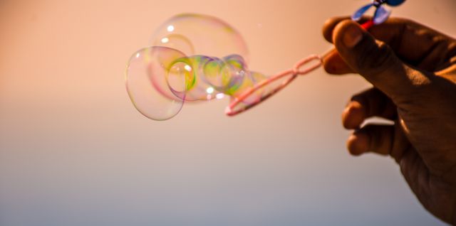 Hand Blowing Soap Bubbles in Sunset Light - Download Free Stock Photos Pikwizard.com