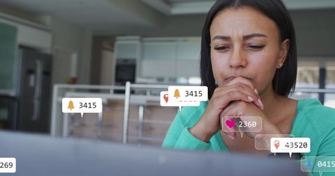 Woman engaging with social media notifications on laptop