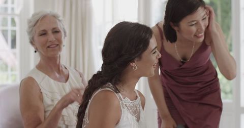 Bride Assisted in Wedding Dress Preparation Indoors