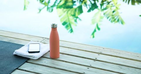 Coral Water Bottle Outdoor Poolside Setting Wellness Concept