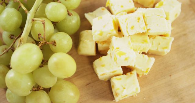 Fresh Green Grapes and Cubed Cheese on Wooden Surface - Download Free Stock Images Pikwizard.com