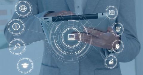 Business professional holding tablet using holographic digital interface with tech icons