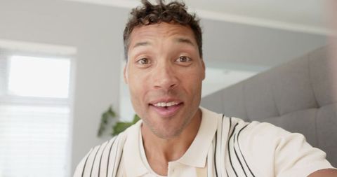 Casual Man Enjoying Video Call in Modern Bedroom