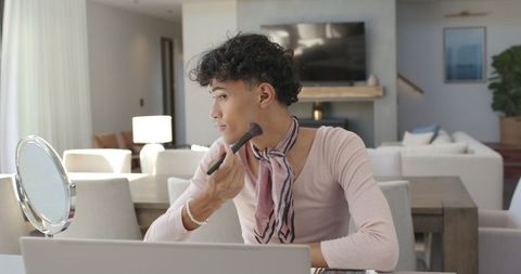 Young Man Applying Makeup in Modern Home Interior