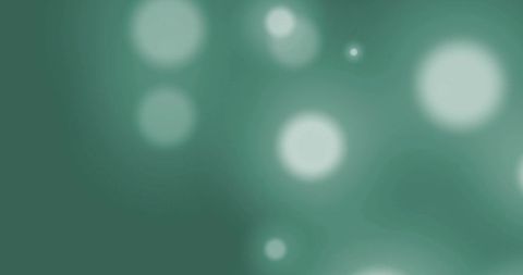 Green abstract bokeh background with light spots