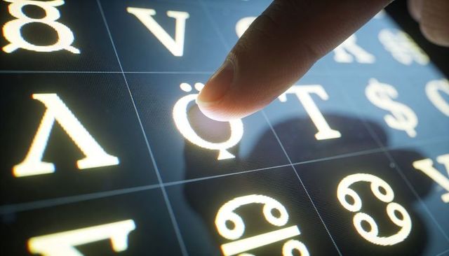 Selecting Glowing Glyph on Touchscreen Grid Showing Pixels and High-Contrast Typography
