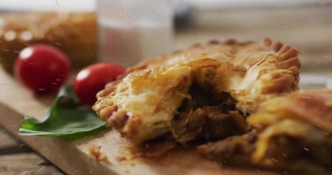 Rustic Savory Pastry on Wooden Cutting Board with Fresh Produce