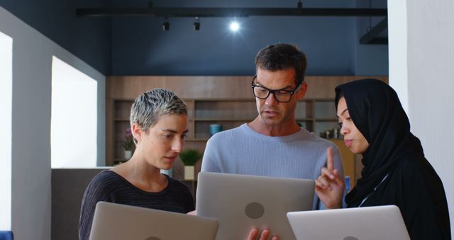 Diverse Team Collaborating on Laptops in Modern Office - Download Free Stock Images Pikwizard.com