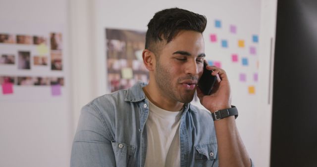 Young Man Talking on Phone in Creative Office Environment - Download Free Stock Images Pikwizard.com