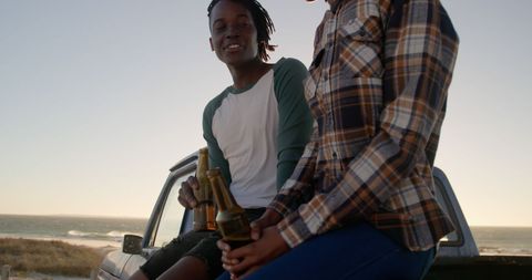 Couple Relaxing on Car at Sunset Beach