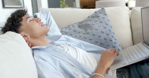 Young Man Relaxing with Laptop at Home