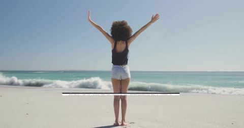 Woman Raising Arms on Sunlit Beach Facing Turquoise Waves Minimalist Travel Freedom