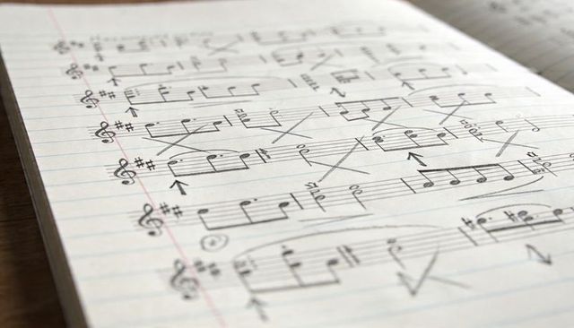 Handwritten Music Notation on Lined Notebook Showing Practice Corrections and Annotations