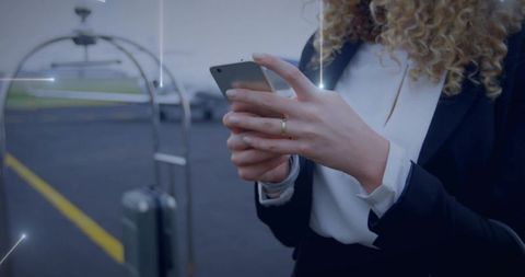 Business traveler checking flight eta on smartphone with digital network overlay