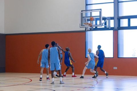Intense Basketball Game in Indoor Gymnasium
