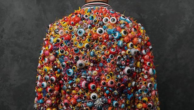 Back view vibrant embellished bomber jacket covered with colorful eye trinkets and beads