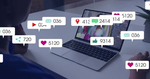 Women collaborating over laptop reviewing retail with social engagement notifications