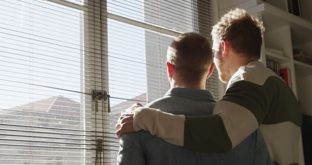 Affectionate Couple Embracing and Looking Through Sunlit Window - Download Free Stock Images Pikwizard.com