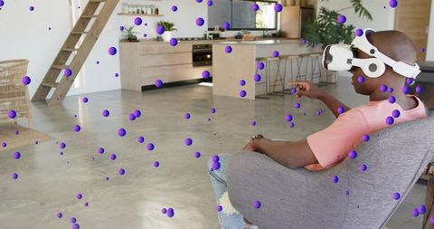 Relaxing man exploring virtual environment with vr headset in modern open-plan loft living room