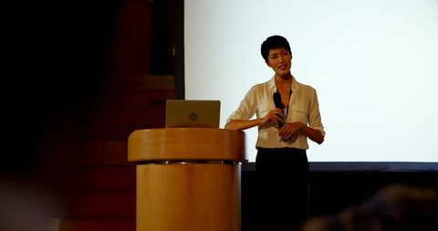 Young asian businesswoman presenting at business seminar