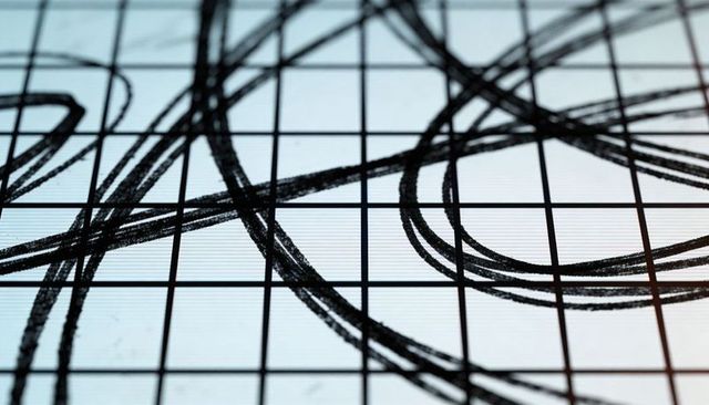 Abstract charcoal loop grid on backlit panel with bold overlapping black circular strokes