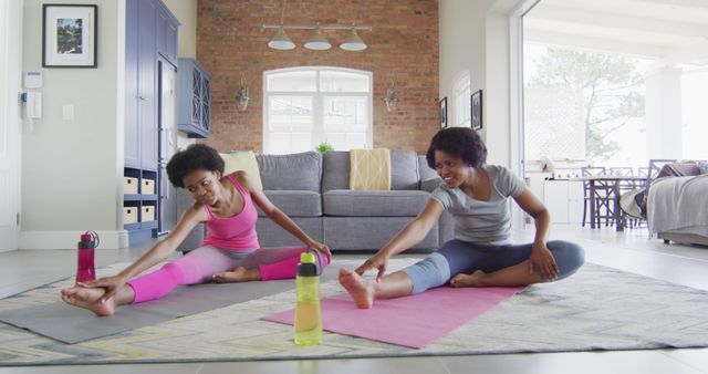 Two Women Doing Yoga Stretches Indoors on Mats - Download Free Stock Images Pikwizard.com