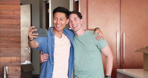 Cheerful Male Couple Taking Selfie at Home