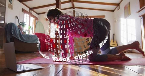 Practicing yoga with blockchain digital overlay during home workout on hardwood floor