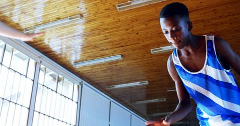 Teen Basketball Player Concentrating in Indoor Court Action Shot