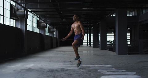 Athletic Man Jumping Rope in Urban Industrial Warehouse
